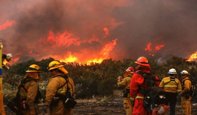California fire destroys 80 buildings, closes highways