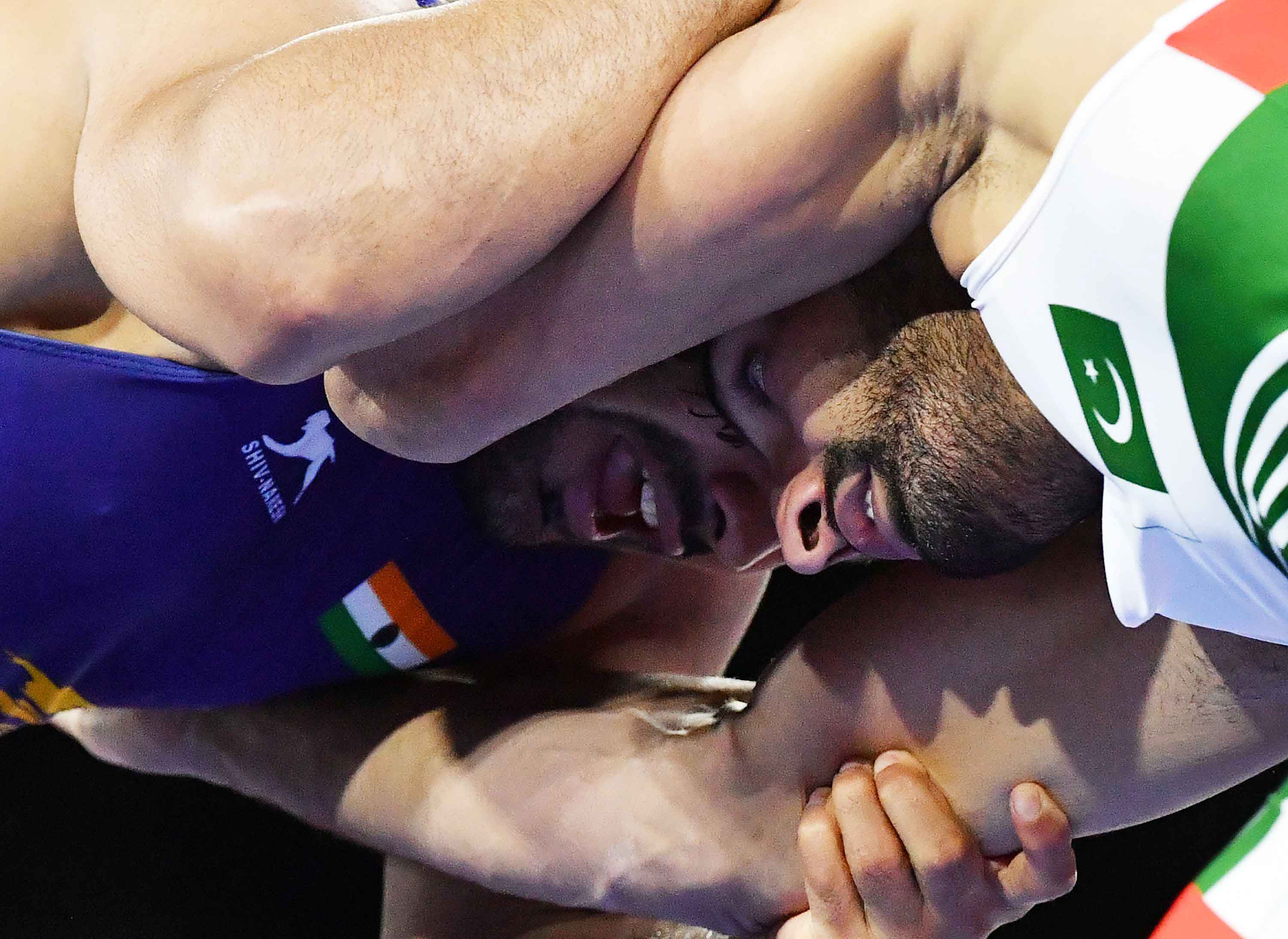 In Pictures: Pakistan's Asad Butt wrestles with India's Kumar Sushil during Commonwealth Games