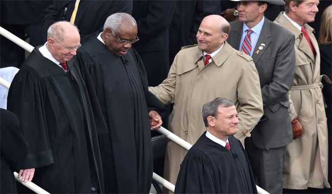 US Chief Justice John Roberts (BottomR), Justice Anthony Kennedy (L) and Justice Clarence Thomas (2nd-L) arrive on the platform of the US Capitol in Washington, DC before the swearing-in ceremony of US President Donald Trump.