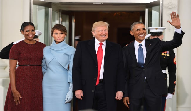 Barack Obama (R) and Michelle Obama (L) welcome President Donald Trump (2nd-R) and his wife Melania to the White House in Washington