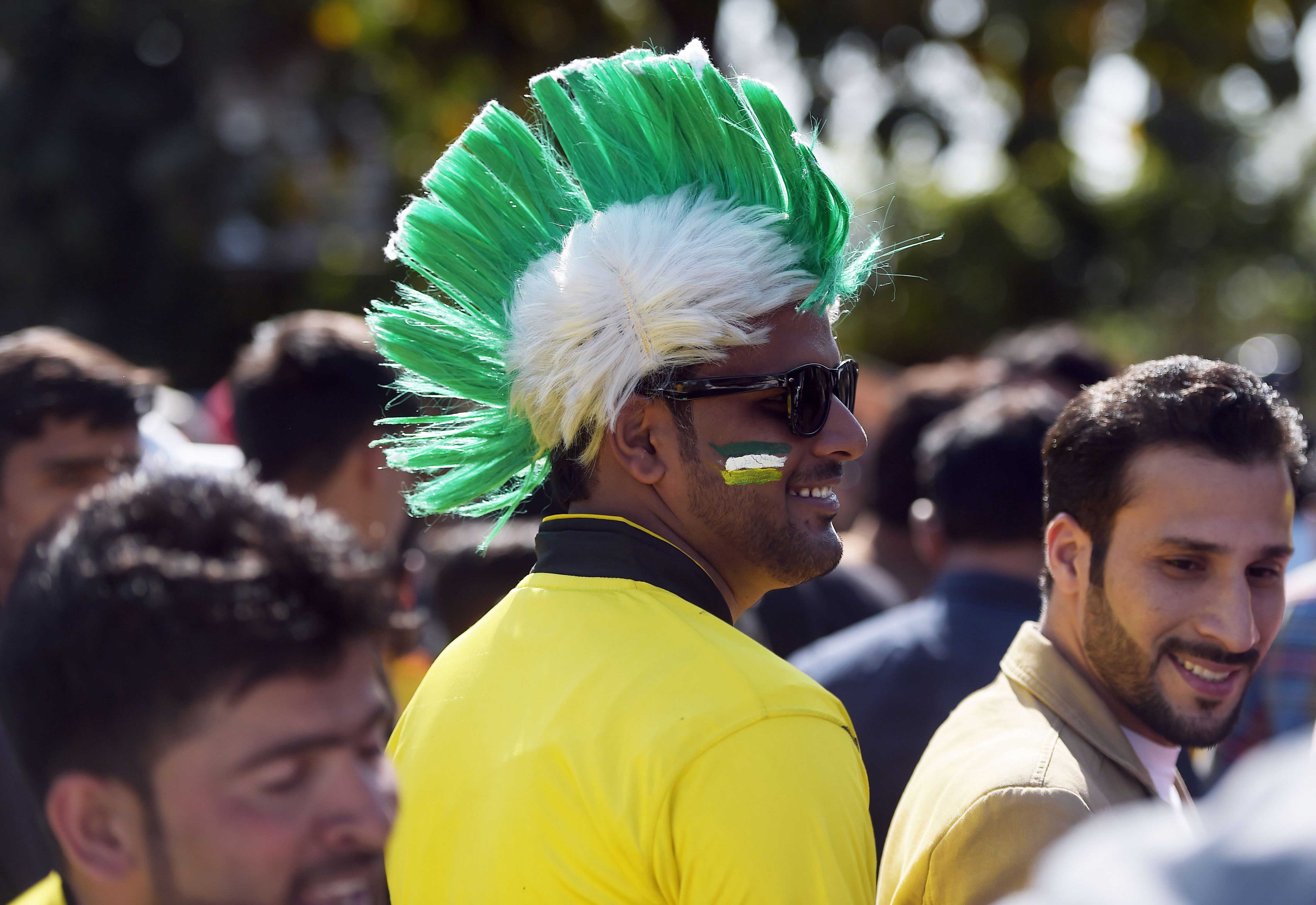 Supporters of Peshawar Zalmi queue at an entry gate of The Gaddafi Cricket Stadium in Lahore.