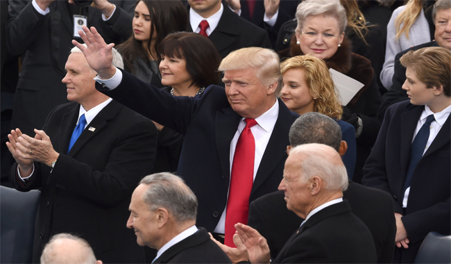 US President Donald Trump (C) arrives for the swearing-in ceremony