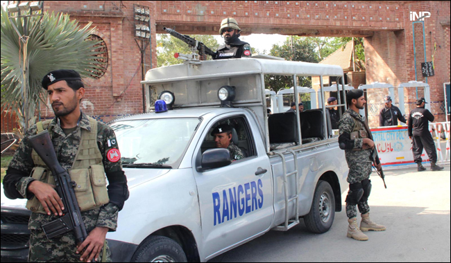 Ranger personnel stand alert in front of Gaddafi Stadium ahead of PSL final
