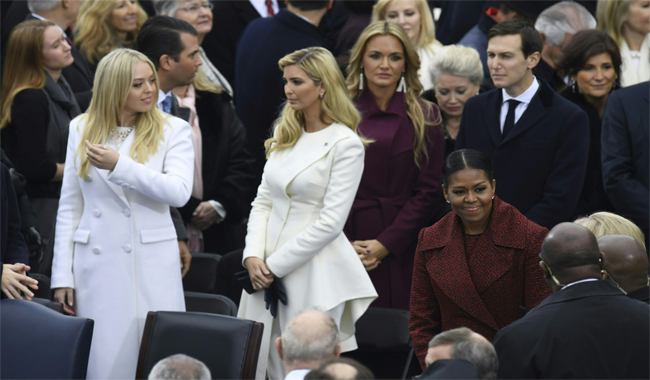 Michelle Obama (bottom R) smiles as the family of President Donald Trump arrive on the platform at the US Capitol in Washington, DC before the swearing-in ceremony.