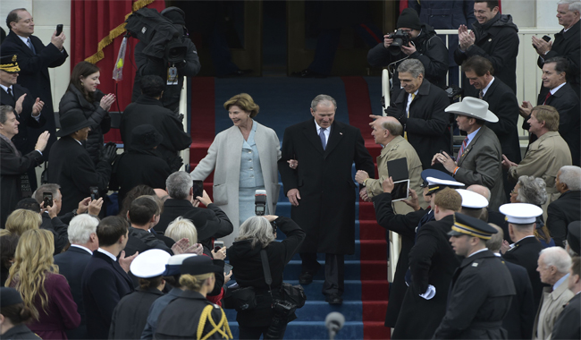 Former Republican president George W. Bush and wife Laura arrive on the platform at the US Capitol in Washington, DC.
