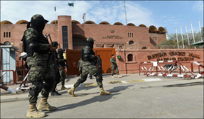 Soldiers patrol outside the Gaddafi Cricket Stadium