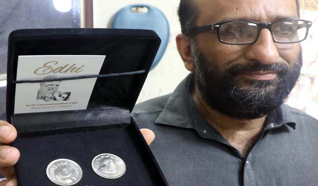  Faisal Edhi, son of late philanthropist Abdul Sattar Edhi and the current head of Edhi Foundation shows Rs50 commemorative coin in memory of his late father.
