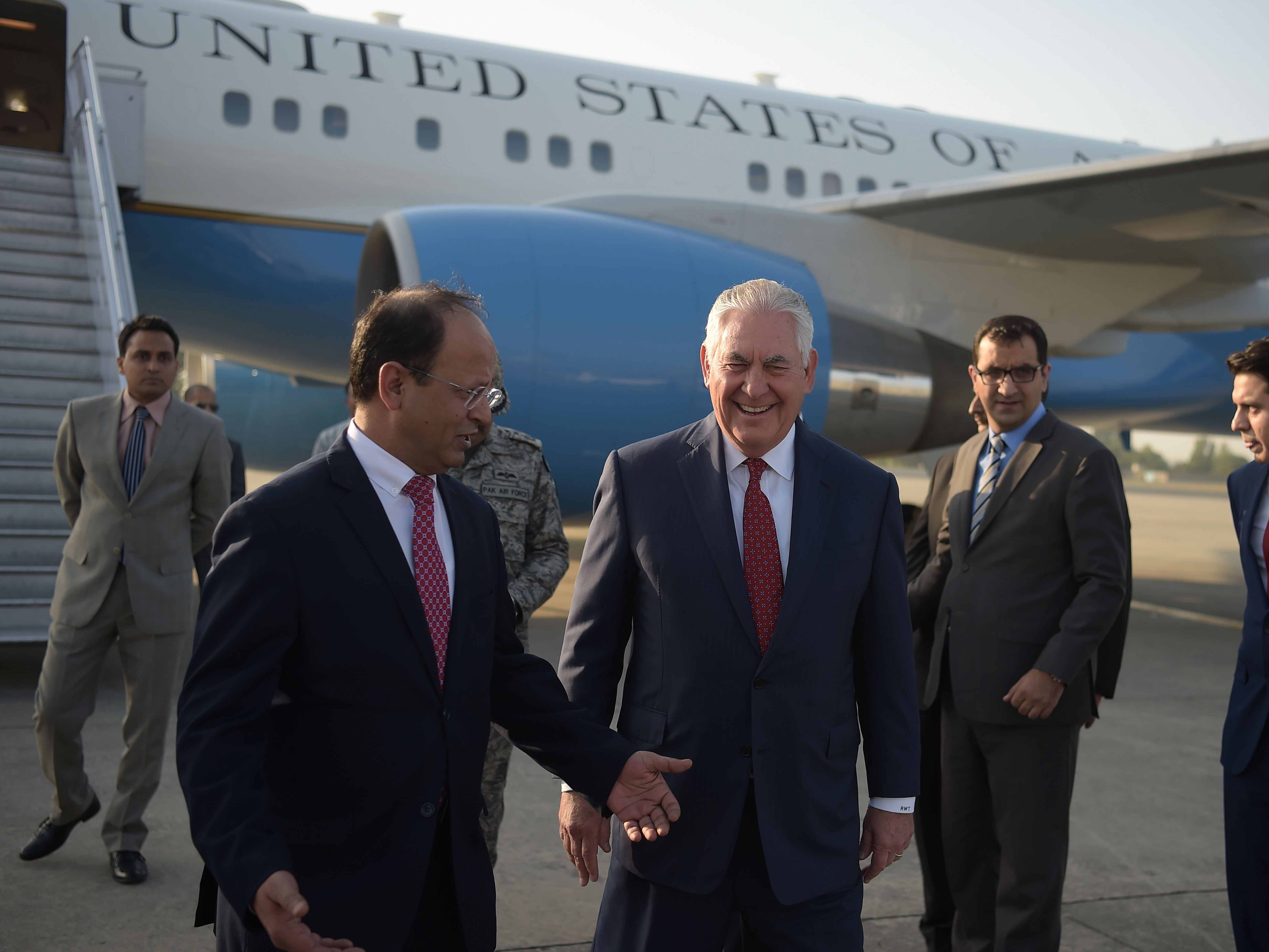 US Secretary of State Rex Tillerson (C) chats with Pakistani foreign office official Sajid Bilal (2nd L) upon his arrival in Islamabad.