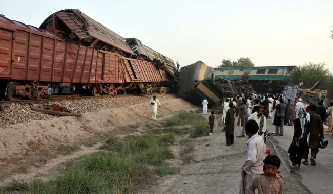 Locals gather at the scene where two trains collided near Multan.