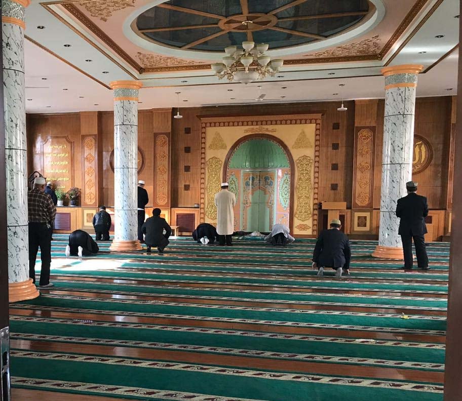 Uighur Muslims performing Zuhar prayer at a Mosque in Urumqi. Photo by author