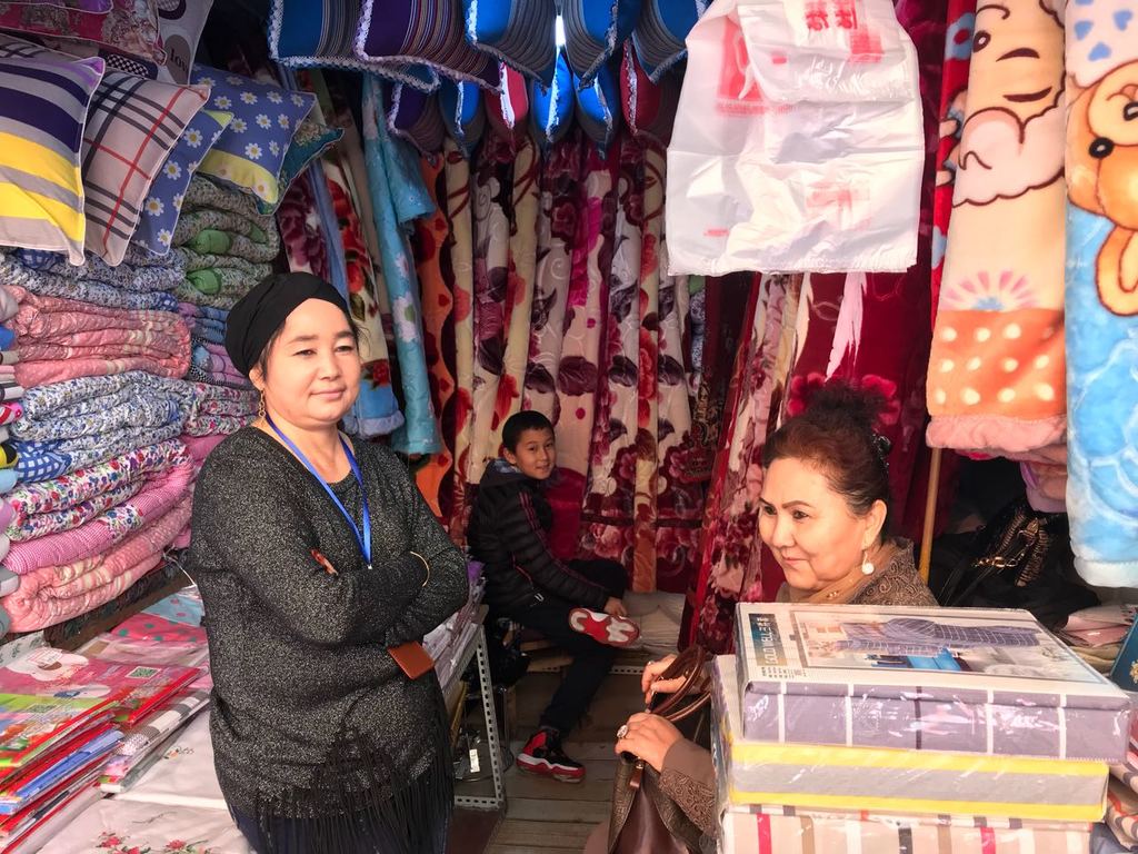 Uighur Muslims selling cloths in one of the main markets of Urumqi