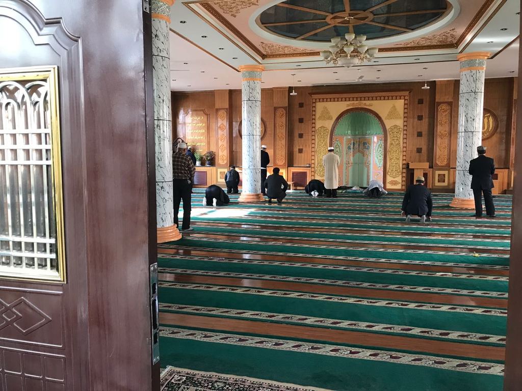 Uighur Muslims performing Zuhar prayer at a Mosque in Urumqi