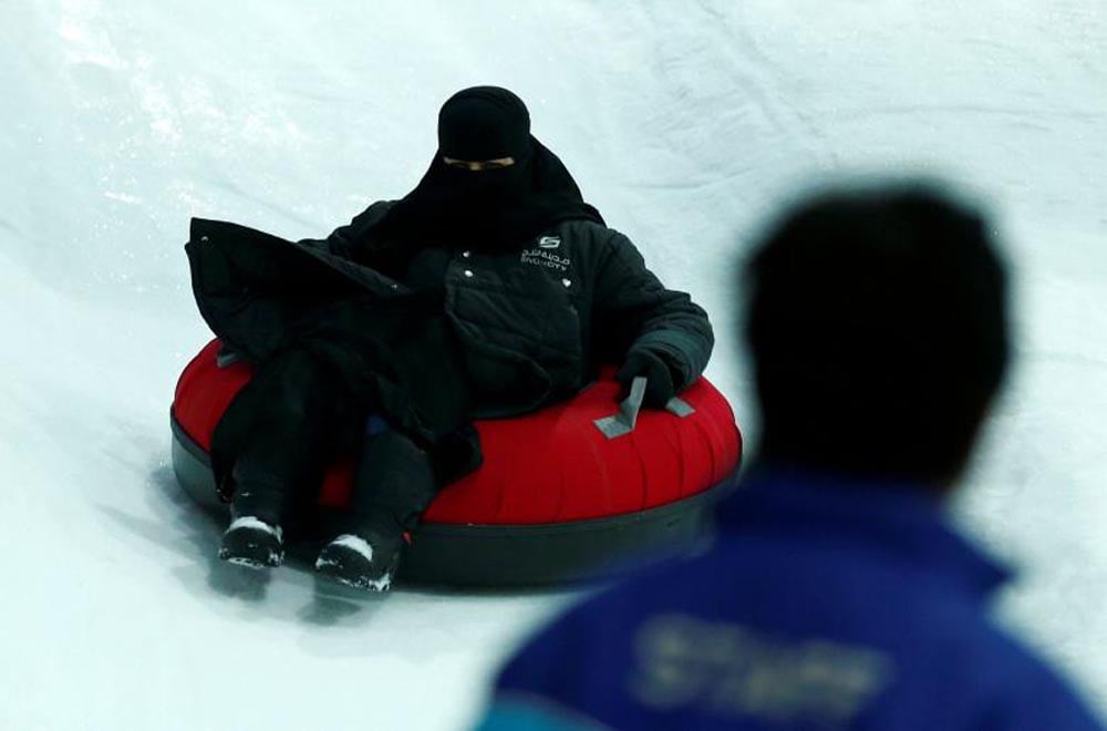 A veiled woman enjoys a ride in the new Snow City at Al Othaim Mall in Riyadh, July 26, 2016. REUTERS