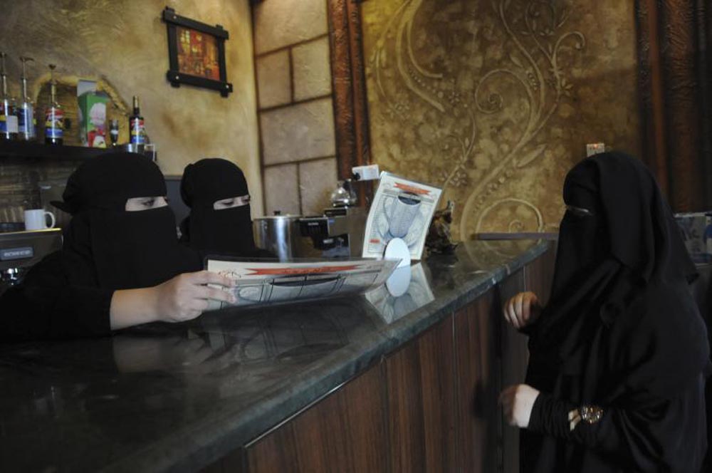 Veiled women work at a coffee shop in Tabuk, November 30, 2013. REUTERS
