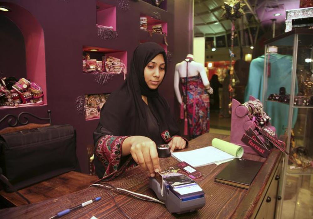 A saleswoman works in a boutique at a mall in Jeddah, January 9, 2012. REUTERS
