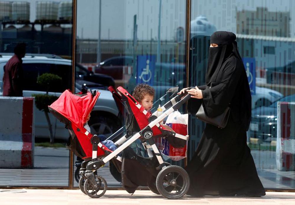 A woman pushes a stroller carrying her children in Riyadh, September 27, 2017. REUTERS
