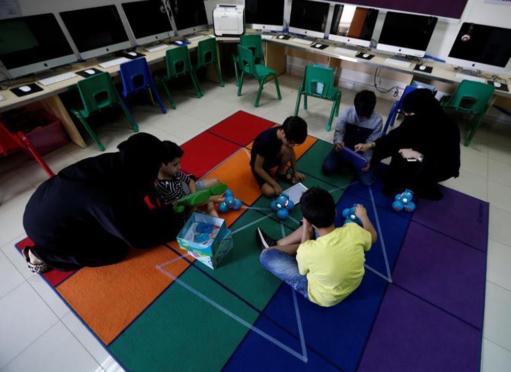 Women teach children computer programming using robots connected with an application as part of Kcoderz social initiative launched by a Saudi couple, in Riyadh, July 29, 2017. REUTERS