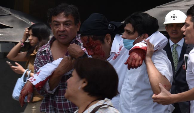 People help a wounded man after an earthquake 