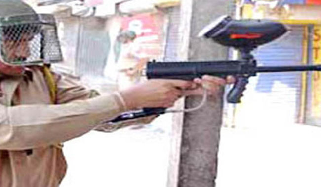 An Indian soldier makes use of a pellet gun to quell protests