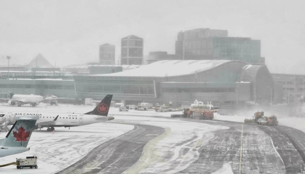 Toronto Pearson airport cancellations spike as snowstorm hits YYZ and YTZ