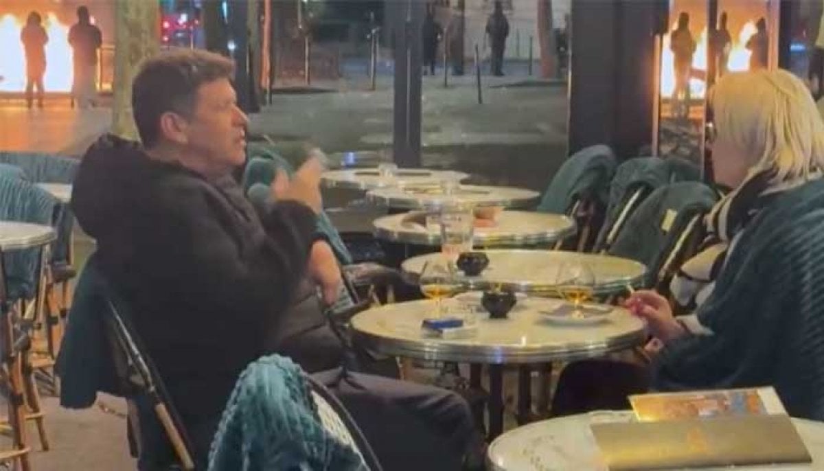 French couple go viral as they keep drinking and smoking amid destruction of Paris 