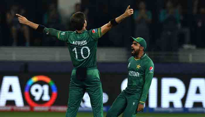 Shaheen Afridi and Babar Azam celebrate after taking a wicket during a match in the T20 World Cup. File