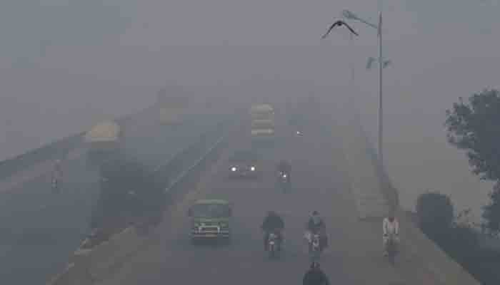 Commuters drive amid heavy smog conditions in Lahore, Pakistan on Nov. 21, 2019. — AFP