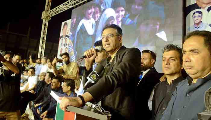 Federal Minister for Planning Asad Umar addressing the PTI District Central Karachi Workers Convention-2021 at Hyderi Market in Karachi. -APP