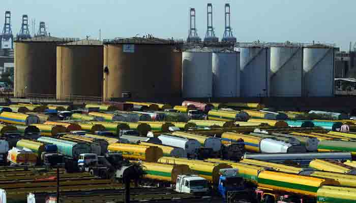 An overview shows tankers parked outside a local oil refinery in Karachi on February 22, 2011. -AFP