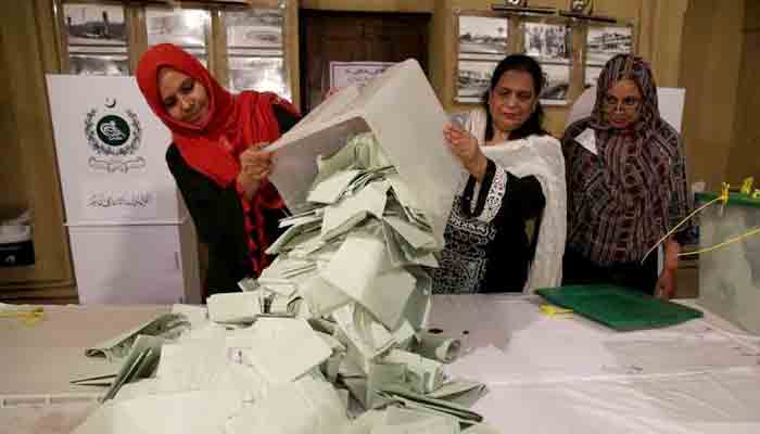 ECP officials counting ballot papers after voting ended in KP local bodies polls. File photo
