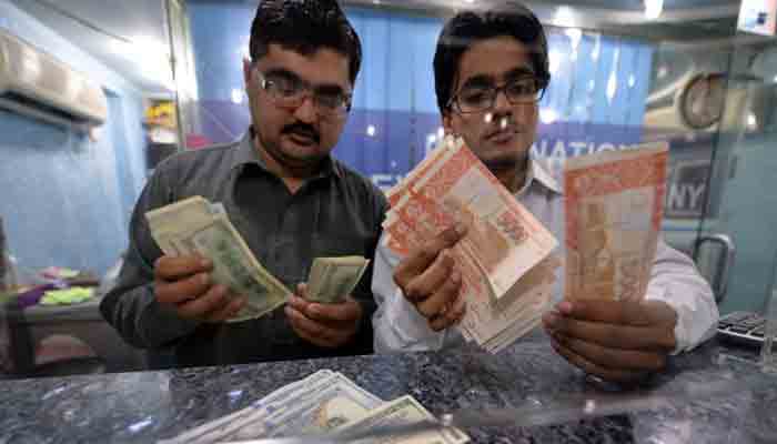 Forex dealers counting currency notes in this file photo.
