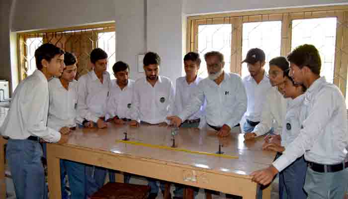 A teacher explaining students at a Physics lab in Sindh Muslim Science College, Karachi.-File photo