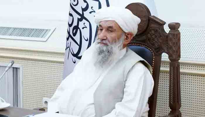 Mullah Hasan Akhund photographed sitting on a chair during a meeting. Photo: Taliban Spokesperson in Doha Mohammad Nadeem.