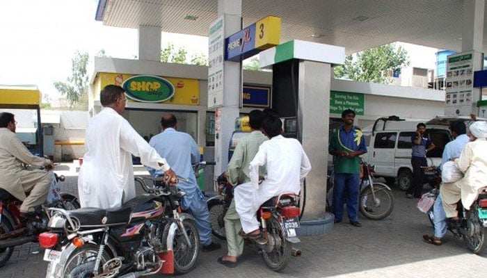 Motorcyclists queued up at a petrol station. -PPI