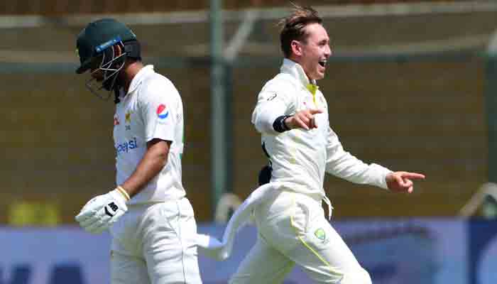 Australia´s Marnus Labuschagne (R) celebrates after the dismissal of Pakistan´s Abdullah Shafique during the third day of the second Test cricket match between Pakistan and Australia at the National Cricket Stadium in Karachi on March 14, 2022.-AFP