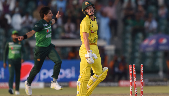 Australias Nathan Ellis (R) reacts after being bowled by Pakistans Mohammad Wasim (L) during the third and final one-day international (ODI) cricket match between Pakistan and Australia at the Gaddafi Cricket Stadium inLahoreon April 2, 2022. -AFP