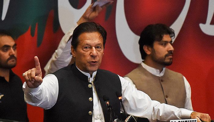 Former Pakistans prime minister Imran Khan, who was ousted by opposition parties through a no-confidence motion, gestures as he addresses Pakistan Tehreek-e-Insaf (PTI) party workers during a party convention in Lahore on April 27, 2022. -AFP