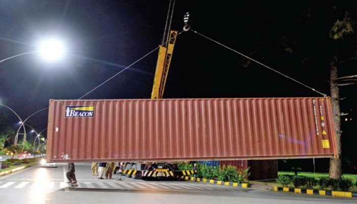 A container is being placed to block the main road to stop the PTIs Azadi March. Photo: Twitter