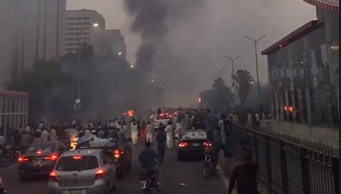 The PTI supporters and workers gathering at D Chowk as heavy shelling clouds the atmosphere. Photo: Twitter