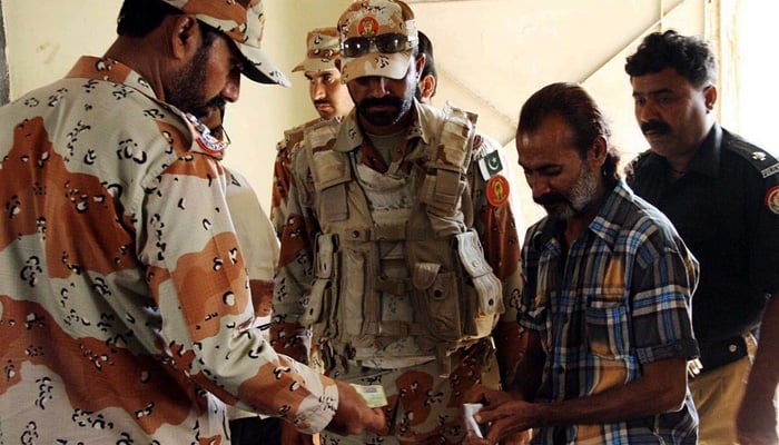 In this 2015 file photo Rangers personnel checking identification documents of polling agents at a polling station in Karachi. -Online