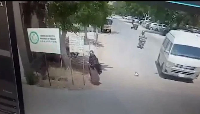 A female suicide bomber is seen outside the gate of the Karachi University. Photo: Screengrab of a CCTV footage.