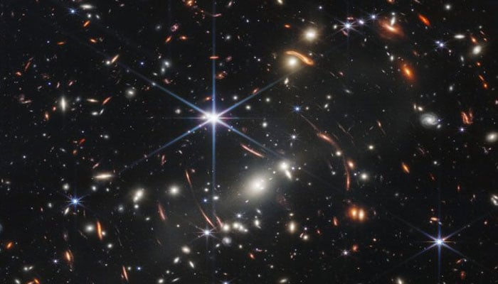 In this screen grab of a White House broadcast the first infrared image from the James Webb Space Telescope (JWST) is seen during a briefing with US President Joe Biden and National Aeronautics and Space Administration (NASA) officials in the South Court Auditorium at the White House in Washington, DC, on July 11, 2022. -AFP
