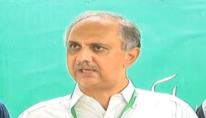 PTI leader Omar Ayub Khan talking to the media after filing a petition in the ECP on July 13, 2022. Photo: Twitter