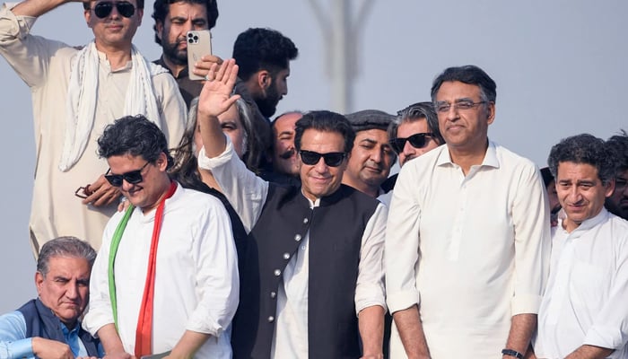 Ousted prime minister Imran Khan (C) waves at his party supporters during a rally in Islamabad. — AFP/File