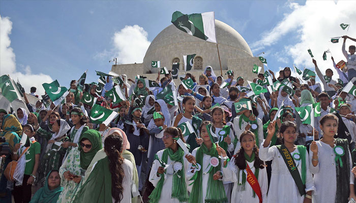 Students waving national flags at the mausoleum of the founder of Pakistan Muhammad Ali Jinnah during a ceremony to mark the country’s Independence Day, —ONLINE/ Sabir Mazhar