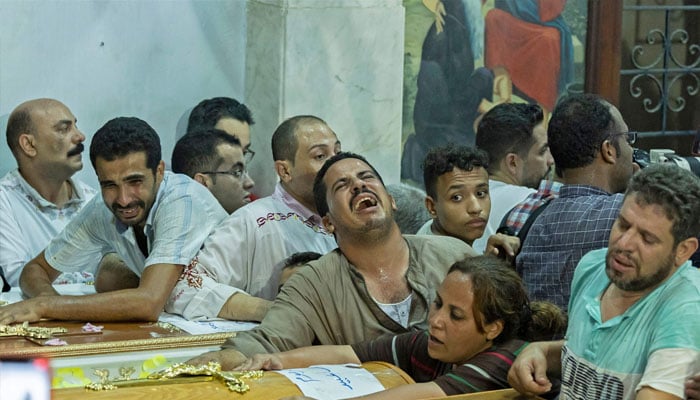 Egyptian mourners react during the funeral of victims killed in Cairo Coptic church fire.—AFP
