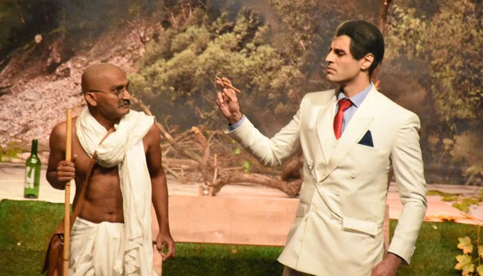 Artists play the characters of Indias founding father Mahatma Gandhi (left) and Quaid-e-Azam Muhammad Ali Jinnah during the theatre play Saadhay 14 August in Karachi, on August 16, 2022. — Arts Council