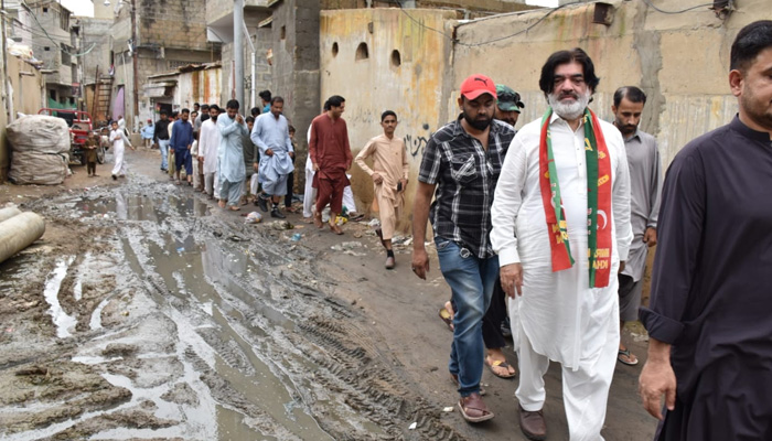 PTIs mayoral candidate for the upcoming local government elections Muhammad Ashraf Jabbar Qureshi visit his constituency in this undated photo. — PTI