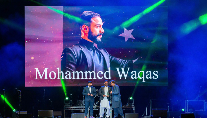Mohammed Waqas receives award at a London ceremony. -Photo by author