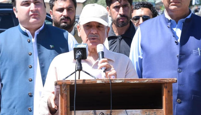 PM Shehbaz Sharif during visit to flood affected areas. —PID
